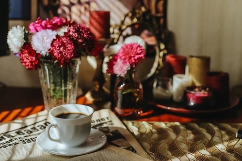 A cozy coffee setup with flowers and candles, perfect for a simple homemade Mother’s Day brunch.