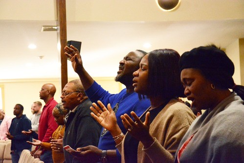 Person worshipping with raised hands