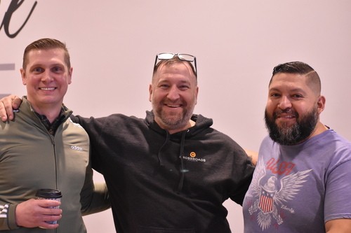 Three men smiling together at Crossroads Church