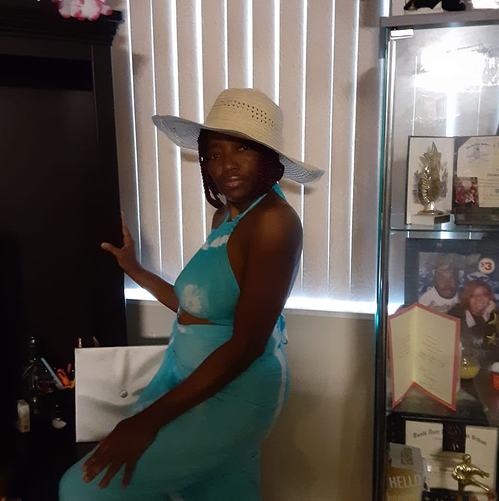 Black women with white hat and light blue dress
