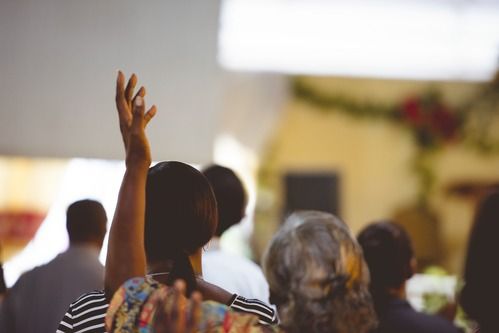 a sanctuary full of people worshiping at full deliverance baptist church