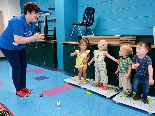 RCC Kids volunteer engaging a group of toddlers during Sunday classroom activities at Restoration City Church.
