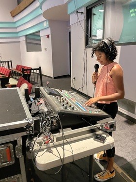 Production team member managing sound and audio equipment during a Sunday service at Restoration City Church.