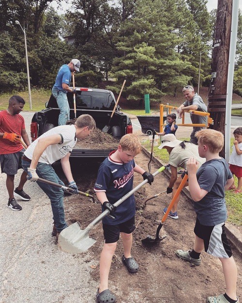 Restoration City Church volunteers of all ages serving together during a local community service project.