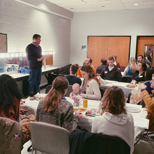 Lead Pastor John McGowan speaking to a group of new attendees during a welcome lunch at Restoration City Church.