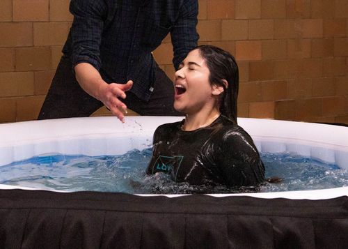 Woman being baptized.