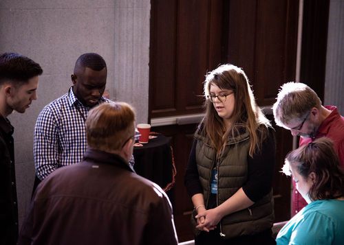 A diverse group praying.