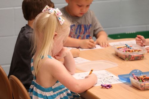 little kids coloring with crayons at church