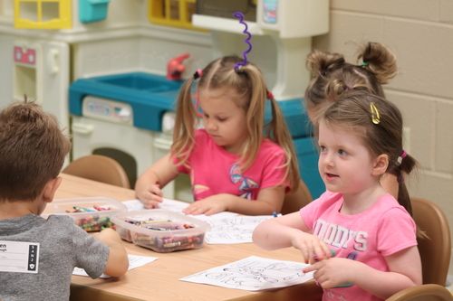 little girls coloring with crayons