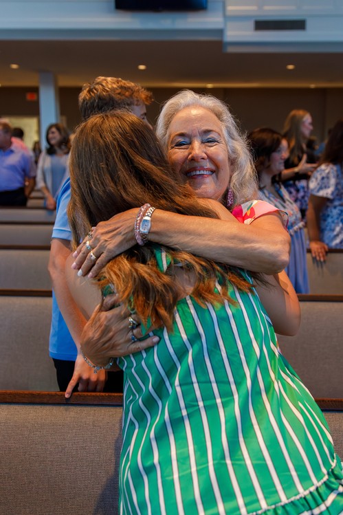 woman hugging another woman at church
