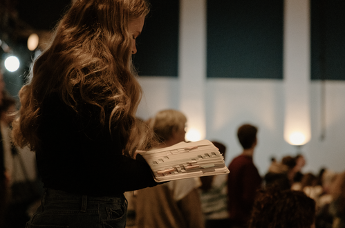 a Bible sitting on someone's lap, open to Ecclesiastes chapter 9