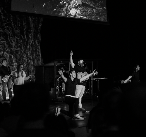 An elderly woman sitting in a classroom listening to a presenter