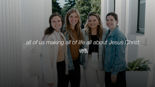 Man preaching at a podium with his arms stretched wide and a Bible in his right hand