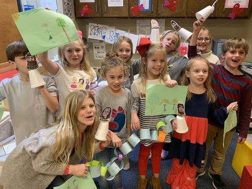 Children in Kids Worship holding a pumpkin craft project