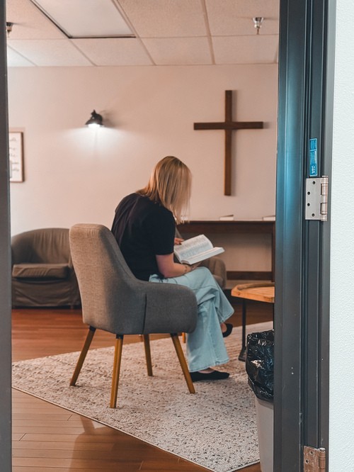 Person reading the bible in our prayer room