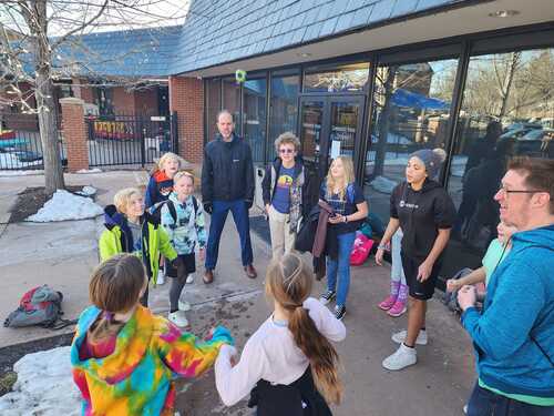 Group of children and teens hanging out outside the community room
