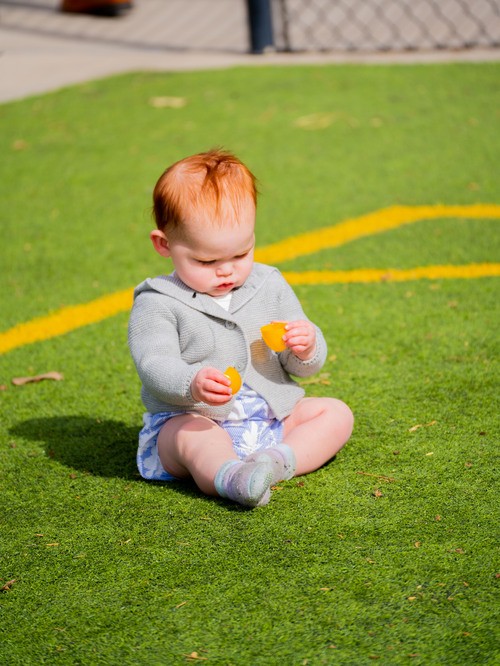 Baby sitting on the grass