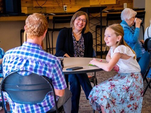 Family sitting together in the community room at St. John's Church