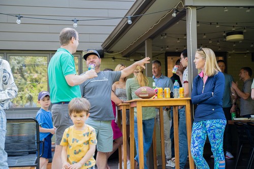 Group of people socializing outside on a deck