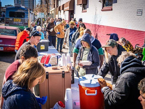 Homeless people being served food by Christ's Body Ministries