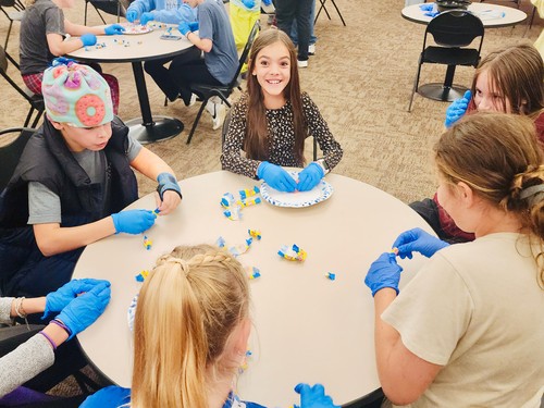 Group of middle school students studying the Bible with leader