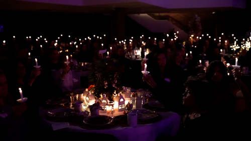 A lot of candles lit in the worship center for the Advent by Candlelight women's event