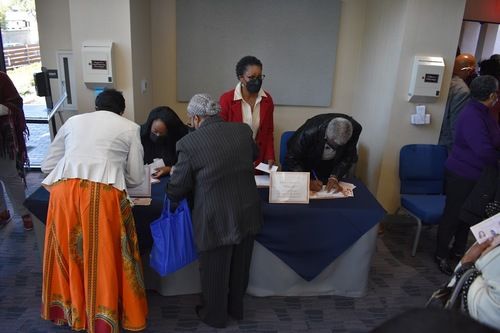 Women's Ministry Team Members help registrants at sign-up table