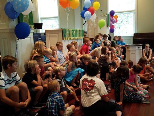 Children sitting on the chancel