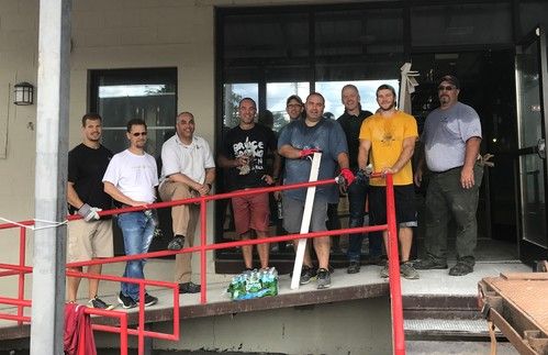 Picture of a group of church members in front of the building during reconstruction.