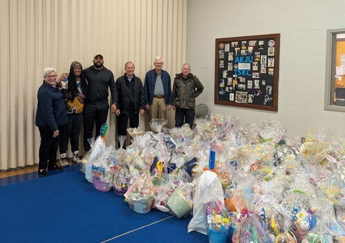 people standing behind Easter baskets