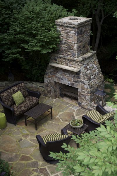 Outdoor fireplace and stone patio built by Landvision Designs